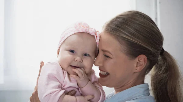 Pleased Mother Holding Arms Infant Girl Headband Bow — Stock Photo, Image