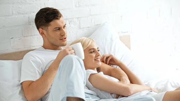 Tattooed Man Holding Cup Coffee Happy Woman Lying Bed — Stock Photo, Image