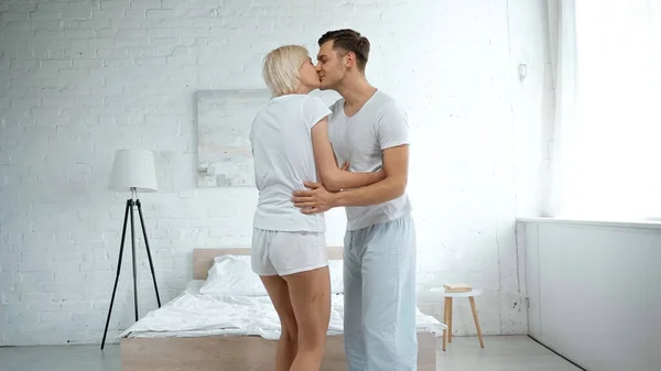 Happy Man Hugging Kissing Blonde Woman Bedroom — Stock Photo, Image