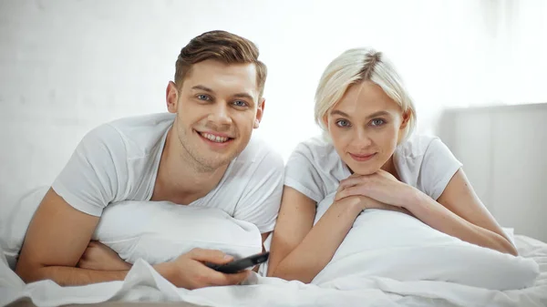 Happy Couple Smiling While Watching Movie Bedroom — Stock Photo, Image
