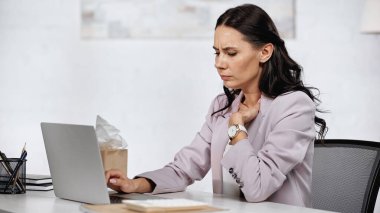 allergic businesswoman feeling unwell near laptop on desk