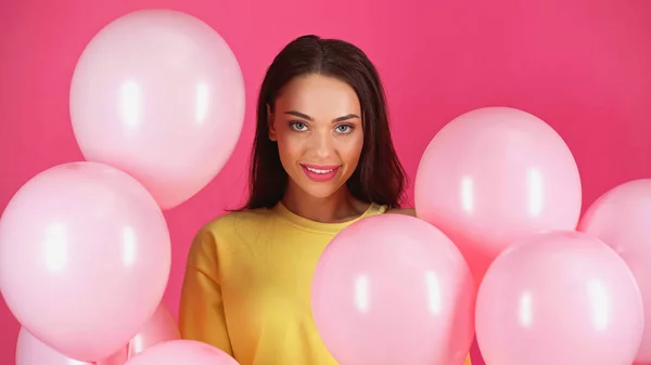 Smiling Young Adult Woman Yellow Blouse Balloons Isolated Pink — Foto de Stock