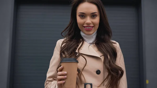 Positive Young Adult Woman Trench Coat Holding Paper Cup Building — ストック写真