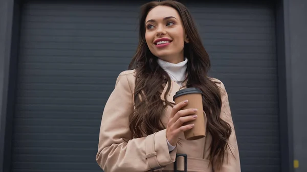 Dreamy Young Adult Woman Trench Coat Holding Paper Cup Looking — Φωτογραφία Αρχείου