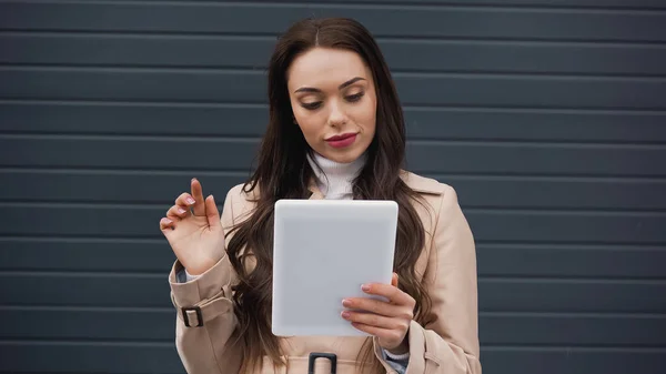 Young Adult Woman Beige Trench Coat Using Tablet Textured Grey — Foto de Stock