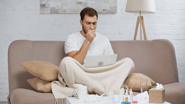 Sick Freelancer Sitting Sofa Using Laptop While Coughing Coffee Table — Fotografia de Stock