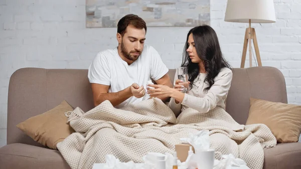 Young Woman Holding Glass Water Sick Man Living Room — Stock Photo, Image
