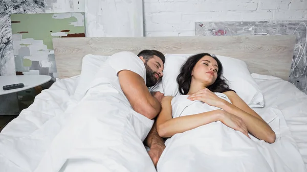 Brunette woman and bearded man sleeping together at home — Stock Photo