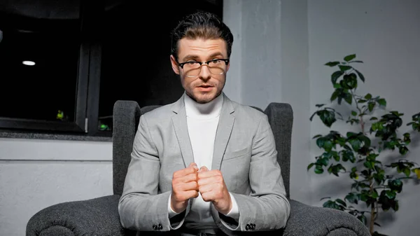 Young businessman with hands in fists looking at camera in office — Stock Photo