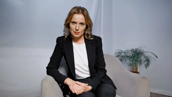 Businesswoman in formal wear looking at camera in office — Stock Photo