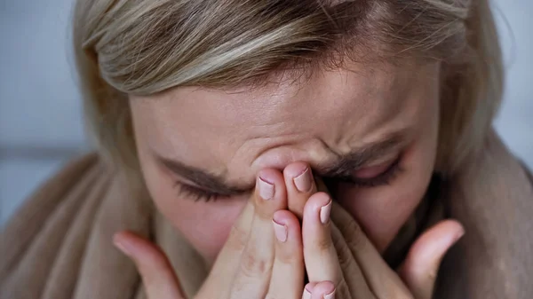 Close up view of sick woman sneezing and covering nose with hands — Stock Photo