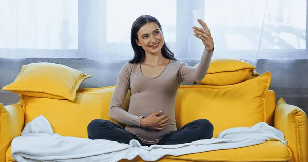 Cheerful pregnant woman taking selfie on smartphone at home — Stock Photo