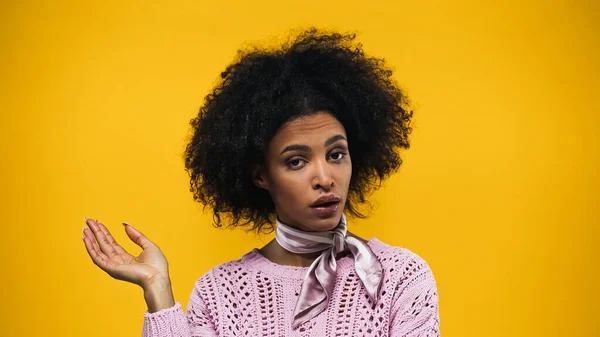 Femme afro-américaine pointant du doigt isolé sur jaune — Photo de stock