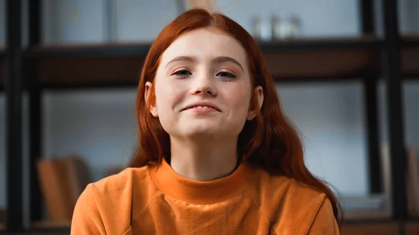 Red haired teenager smiling at camera at home — Stock Photo