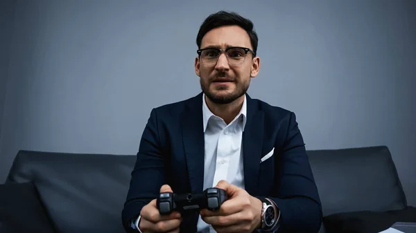 KYIV, UKRAINE - FEBRUARY 13, 2020: Focused business playing video game in hotel room — Stock Photo