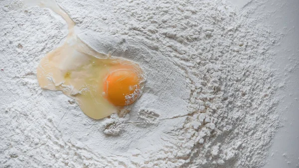 Top view of raw egg in white flour — Stock Photo