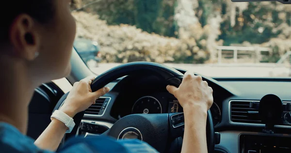 Junge Frau hält Lenkrad während Autofahrt — Stockfoto