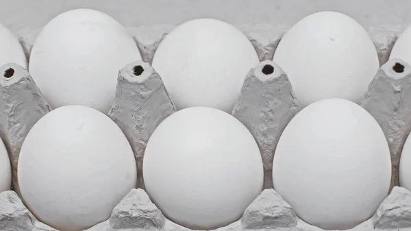 Close up view of chicken eggs in cardboard egg tray — Stock Photo