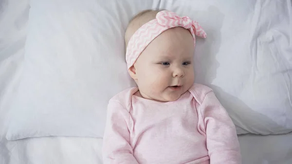 Top view of infant baby lying on bed at home — Stock Photo