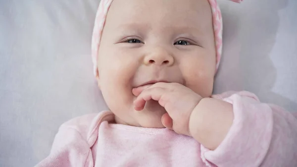 Top view of infant baby sucking fingers — Stock Photo