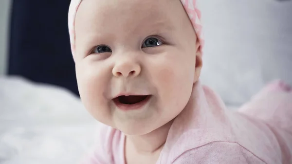 Close up of funny infant baby girl looking at camera — Stock Photo