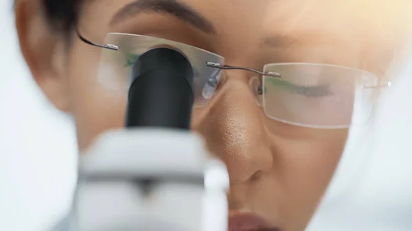Close up of african american scientist in glasses looking through microscope in lab — Stock Photo