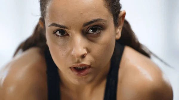 Close up of tired and sweaty sportswoman working out in gym — Stock Photo