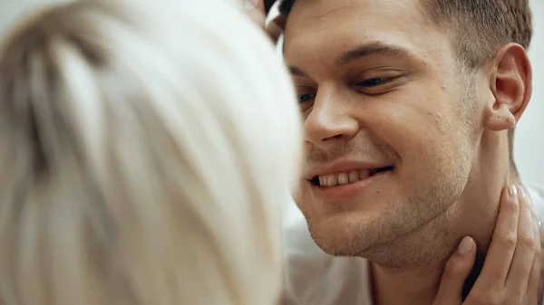 Close up of happy man hugging with girlfriend on blurred foreground — Stock Photo