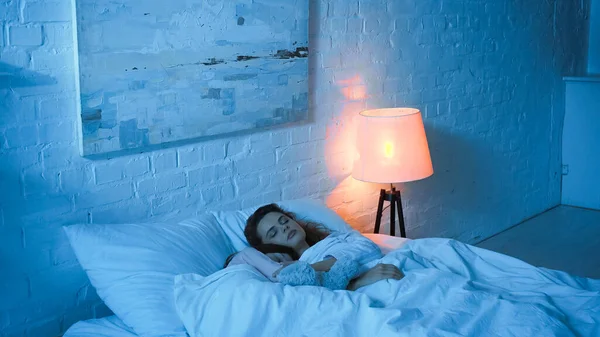 Mother and daughter sleeping near floor map in bedroom — Stock Photo