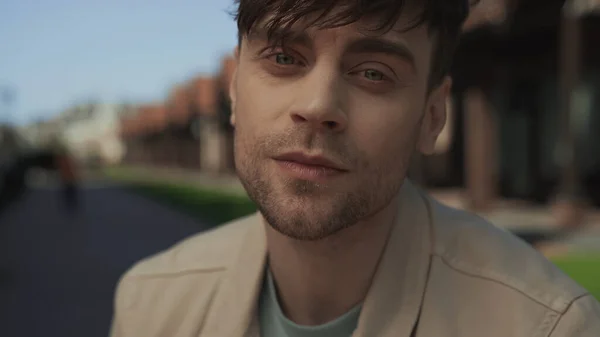 Close up of good-looking man in beige jacket looking at camera — Photo de stock