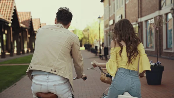 Visão traseira do homem e da mulher andar de bicicleta na rua — Fotografia de Stock