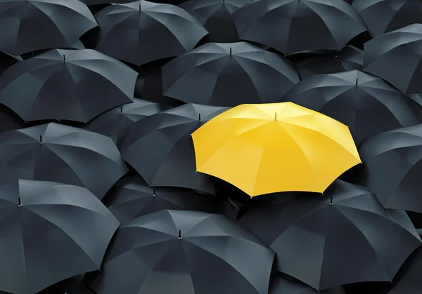 Yellow umbrella among dark ones — Stockfoto