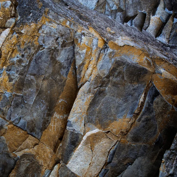 Fragment of rough-hewn stone of dark gray — Stock Photo, Image