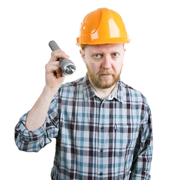 Man in de helm met een zaklamp — Stockfoto