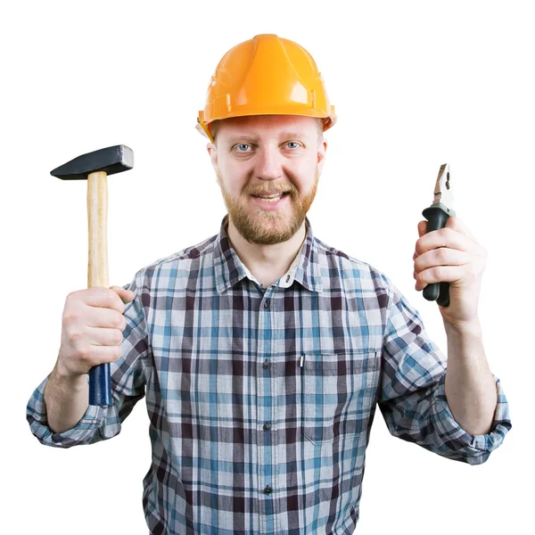 Hombre en casco con un martillo y alicates — Foto de Stock