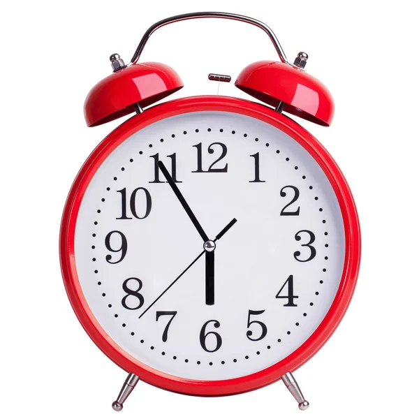 Red alarm clock shows five minutes to six — Stock Photo, Image