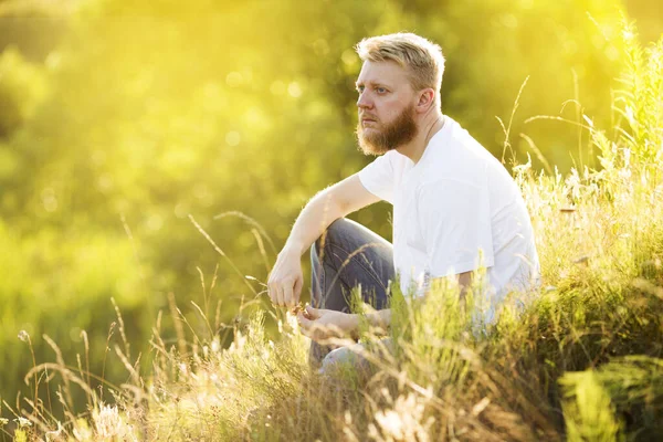 Blonde Bearded Young Man White Shirt Sits Grass Summer Day — Stock Photo, Image