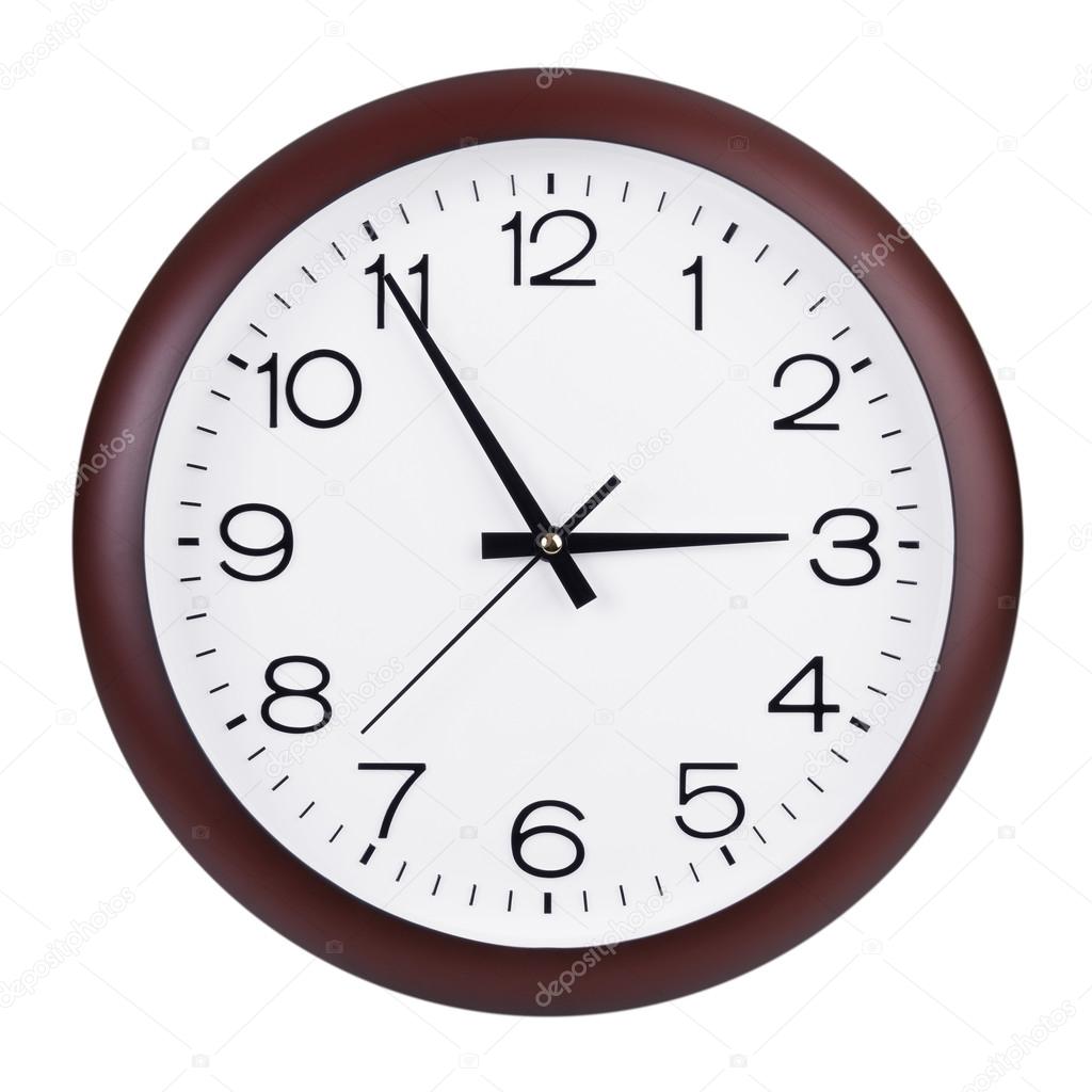 Round clock shows five minutes to three