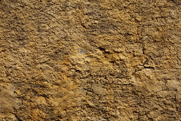 Stone wall yellow in small cracks — Stock Photo, Image