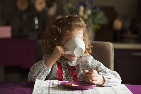 Menina bebendo de um copo branco grande — Fotografia de Stock