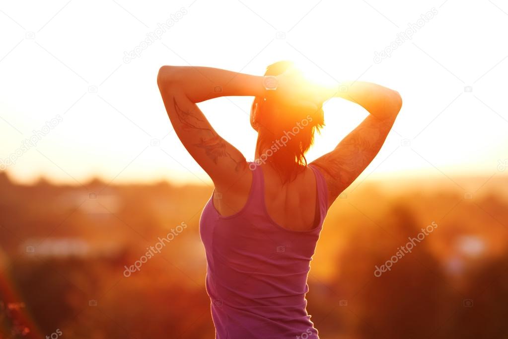 Happy young woman at sunset
