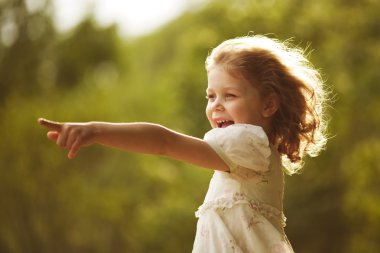 Happy curly girl showing hand forward