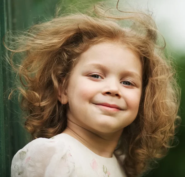 Happy beautiful cheerful curly little girl ストック写真