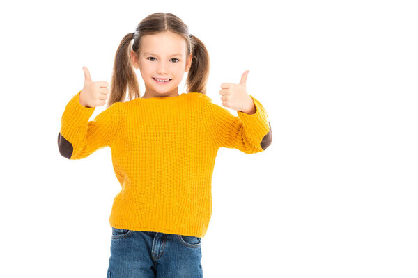 Smiling kid showing thumbs up at camera isolated on white
