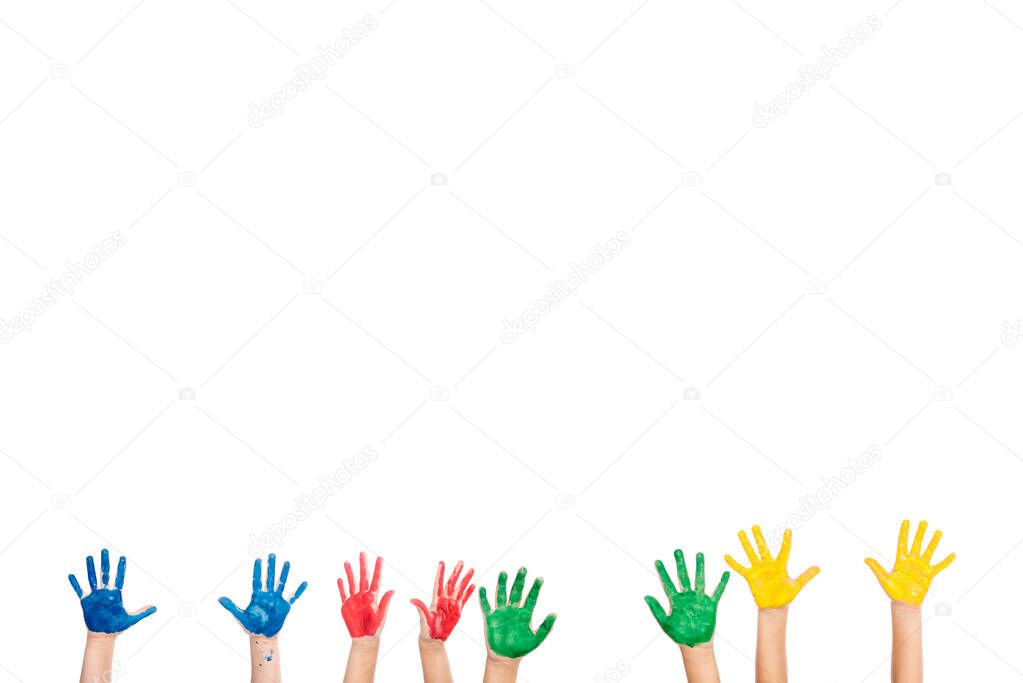 Cropped view of hands of kids in colorful paint isolated on white