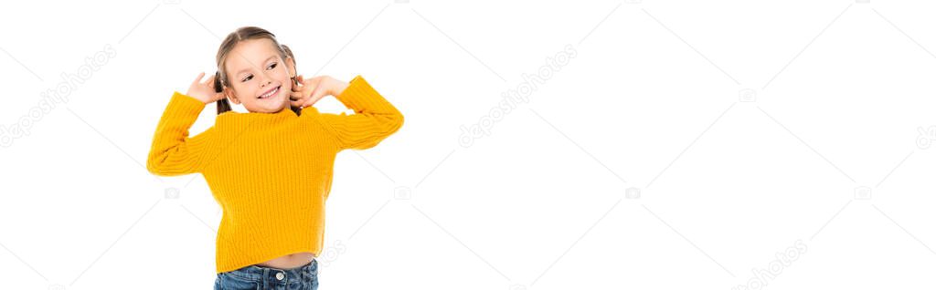 Cheerful girl with hands near head looking away isolated on white, banner 