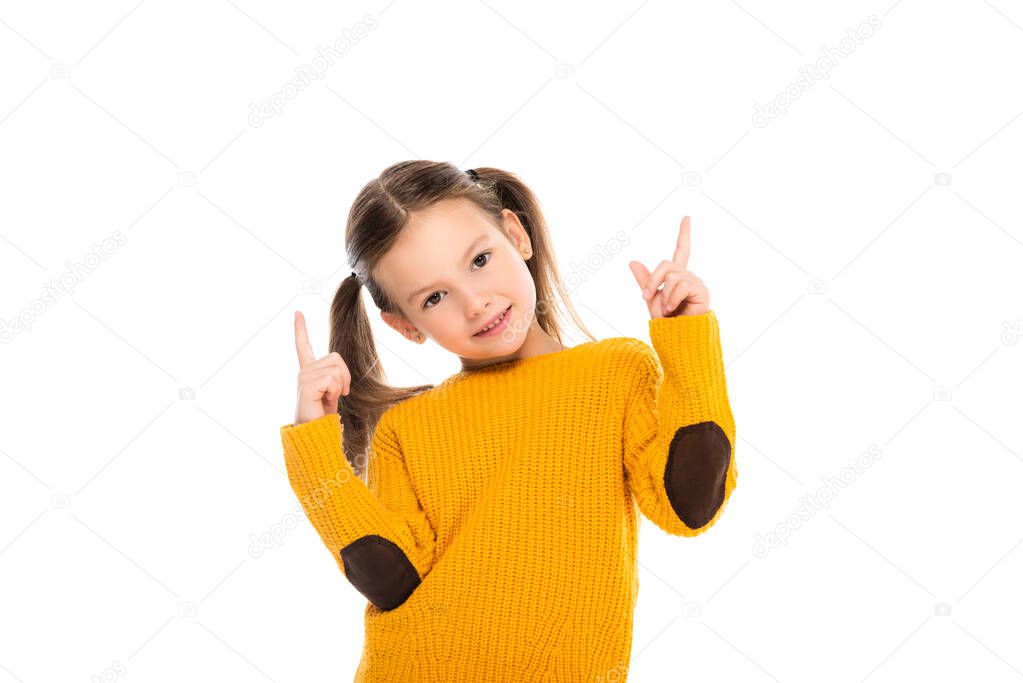 Cheerful girl pointing with fingers up and looking at camera isolated on white