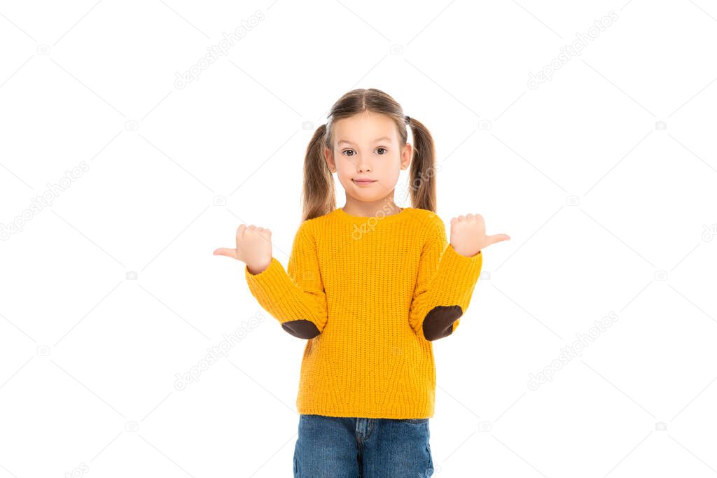 Confused kid pointing away while looking at camera isolated on white