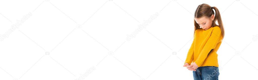 Sad kid looking down while standing isolated on white, banner 