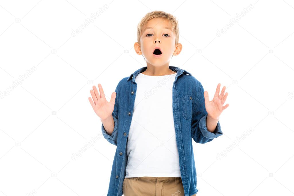 Excited boy gesturing while looking at camera isolated on white